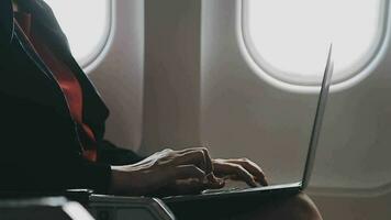 Asian young woman using laptop sitting near windows at first class on airplane during flight,Traveling and Business concept video