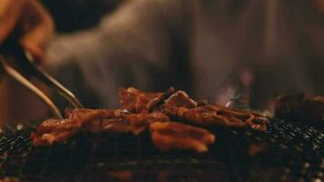 Party for barbecue japanese style, yakiniku. Meats are being cooked on stove in a japanese video