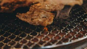 Party for barbecue japanese style, yakiniku. Meats are being cooked on stove in a japanese video