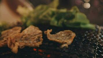 Party for barbecue japanese style, yakiniku. Meats are being cooked on stove in a japanese video