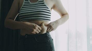 fat woman, fat belly, chubby, obese woman hand holding excessive belly fat with measure tape, woman diet lifestyle concept video