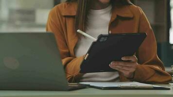Business team working with new startup project plan and discussion information for financial strategy with laptop and digital tablet in a modern business lounge. video