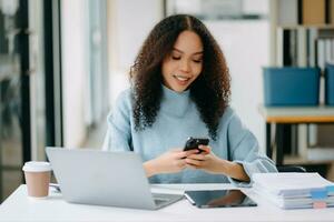 Businesswoman Analyzing Finance on Tablet and Laptop at Office Desk tax, report, accounting, statistics photo