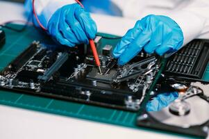 The technician is putting the CPU on the socket of the computer motherboard. electronic engineering electronic repair, electronics measuring and testing, repair photo