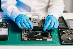 The technician repairing the motherboard in the lab with copy space. the concept of computer hardware, mobile phone, electronic, repairing, upgrade photo