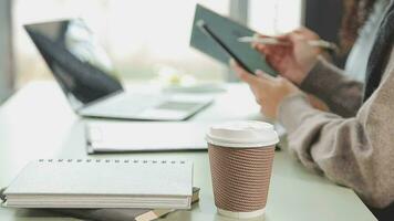 Business team working with new startup project plan and discussion information for financial strategy with laptop and digital tablet in a modern business lounge. video