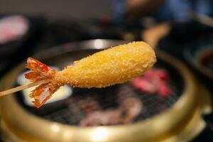 Tempura battered prawns in skewers photo