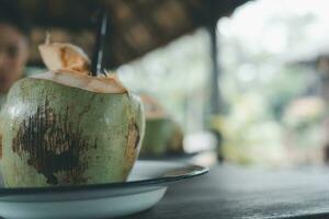 Drinking coconut with straws. Healthy drink photo