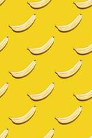 Seamless pattern of bananas on yellow background. photo