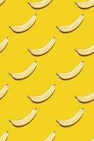 Seamless pattern of bananas on yellow background. photo