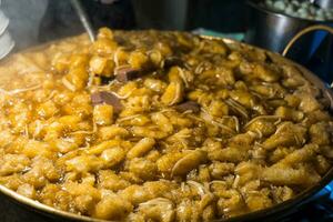 Fish maw soup or braised fish maw in red gravy on big pot photo