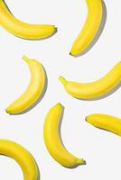 Creative flat lay yellow bananas on white background. photo