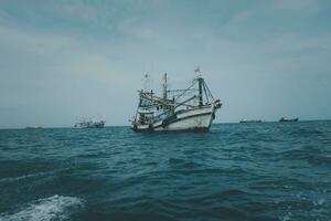 Thai wooden fishing boat sailing sea photo