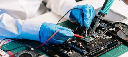 The technician repairing the motherboard in the lab with copy space. the concept of computer hardware, mobile phone, electronic, repairing, upgrade photo