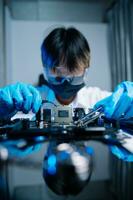 The technician is putting the CPU on the socket of the computer motherboard. electronic engineering electronic repair, electronics measuring and testing, repair photo