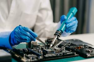 The technician is putting the CPU on the socket of the computer motherboard. electronic engineering electronic repair, electronics measuring and testing, repair photo