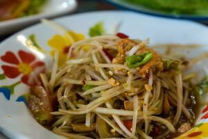 Spicy papaya salad with fermented fish photo