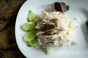 Rice steamed with chicken soup with cucumber, liver photo