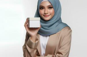 AI generated asian woman wearing hijab hold a white box isolated on white background photo