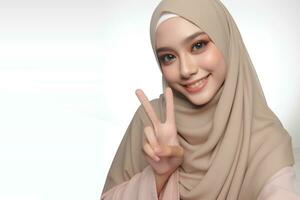 AI generated Muslim woman with isolated peace hands pose on white background photo