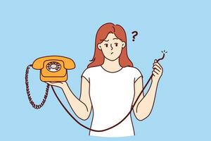 Embarrassed woman holding retro telephone with torn wire, and is wondering how to restore telephony vector