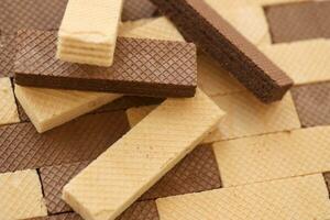 Stacked delicious chocolate wafers in large amount. Two different flavours of classic waffles photo