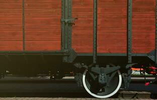 The side of the old brown wooden freight car with the wheel of the times of the Soviet Union photo