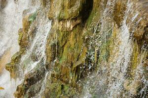 Beautiful waterfall between large rocks in autumn forest. Sofievskiy park in Uman, Ukraine photo