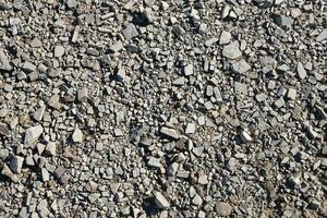 antecedentes de destrozado pedregoso piedras superficie en montaña área. textura con natural ligero foto