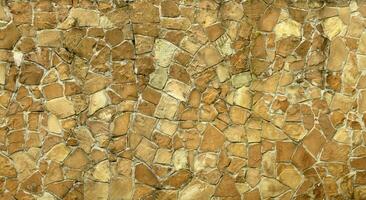 Very old brick stone wall of castle or fortress of 18th century. Full frame wall with obsolete dirty and cracked bricks photo