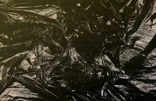 Texture of black plastic garbage disposable bag photo