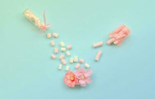 Concept of care for flowers. Pink flower sprinkled with marshmallows photo