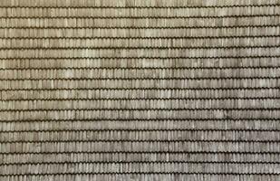 Gray wooden roof tiles background texture. A close up of old gray roof covered with wooden tiles photo