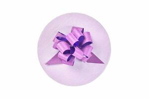 Round gift box with bow, top view, isolated photo