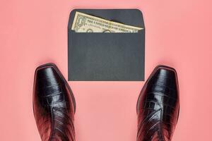 Woman shoes and an envelope with money photo