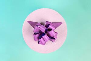 Round gift box with bow, top view photo