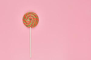 Sweet lollipop on pink background photo