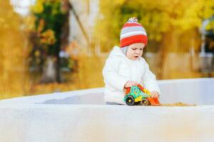 child playing excavator on the street photo