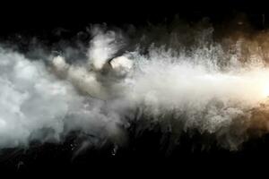 White powder explosion.Freeze motion of white dust particles on black background. photo