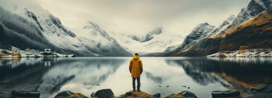 AI generated a person standing by a lake with mountains in the background photo