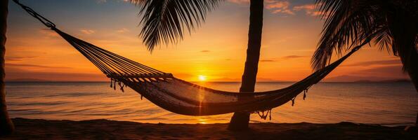 AI generated Hammock Suspended Between Palm Trees with Sunset Backdrop and Space for Text photo