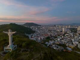 Aerial view of Vung Tau city, Vietnam, panoramic view of the peaceful and beautiful coastal city behind the statue of Christ the King standing on Mount Nho in Vung Tau city. photo