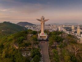 Aerial view of Vung Tau city, Vietnam, panoramic view of the peaceful and beautiful coastal city behind the statue of Christ the King standing on Mount Nho in Vung Tau city. photo