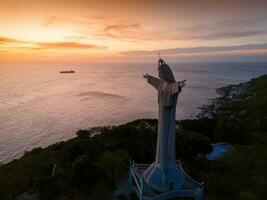 Aerial view of Vung Tau city, Vietnam, panoramic view of the peaceful and beautiful coastal city behind the statue of Christ the King standing on Mount Nho in Vung Tau city. photo