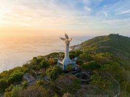 Aerial view of Vung Tau city, Vietnam, panoramic view of the peaceful and beautiful coastal city behind the statue of Christ the King standing on Mount Nho in Vung Tau city. photo