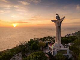 Aerial view of Vung Tau city, Vietnam, panoramic view of the peaceful and beautiful coastal city behind the statue of Christ the King standing on Mount Nho in Vung Tau city. photo