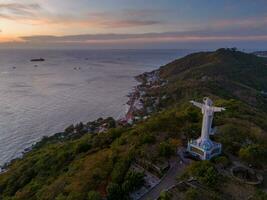 Aerial view of Vung Tau city, Vietnam, panoramic view of the peaceful and beautiful coastal city behind the statue of Christ the King standing on Mount Nho in Vung Tau city. photo