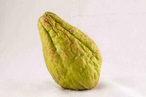 a ripe green chayote on a white background photo