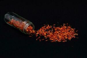 saffron flowers in a glass jar photo