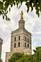 a tower with a gold statue on top of it photo